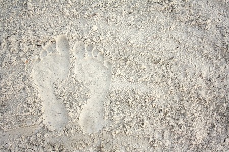 A pair of footprints are side by side in the soft white beach sand, with room for text, copyspaceの写真素材