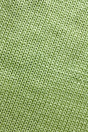a background of sage green colored knit fabric is braided in lines