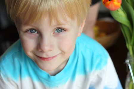 head and shoulders portrait of a sweet young child at home, smiling peacefully