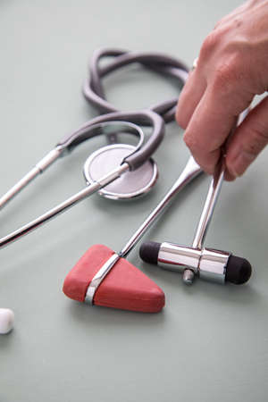 Female neurologist working with buck reflex hammerの写真素材