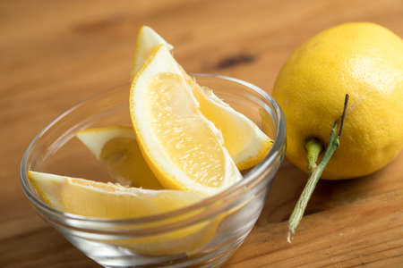 Fresh lemon carving with stalk in glass bowlの写真素材