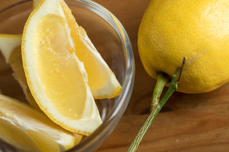 Fresh lemon carving with stalk in glass bowlの写真素材