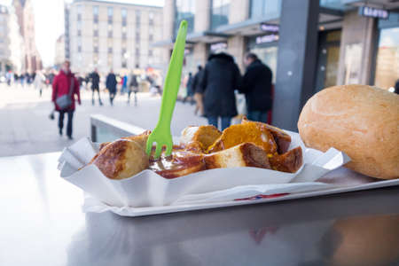 Currywurst a typical german street food grilled and sliced ??sausage with curry ketchupの写真素材