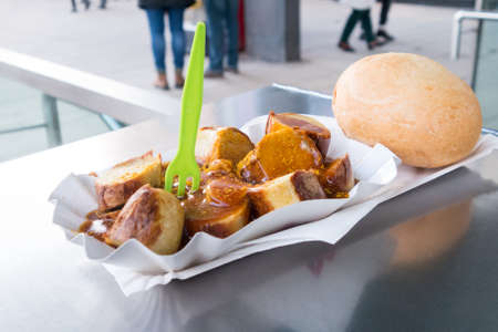 Currywurst a typical german street food grilled and sliced ??sausage with curry ketchupの写真素材