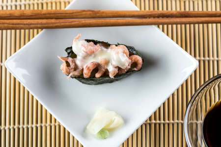 German north sea shrimp in japanese nigiri sushi with wooden chopsticks as appetizerの写真素材