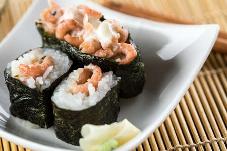 Japanese North Sea Shrimp in Japanese Nigiri and Maki Roll Sushi with wooden chopsticks as appetizerの写真素材