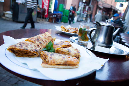 Moroccan mint tea and pancake crepes in Marrakech street caféの写真素材