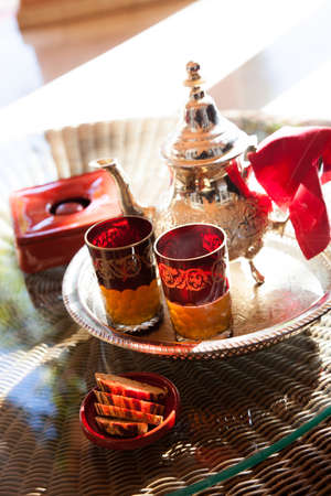 Moroccan mint tea with glass and teapot in Marrakech cafÃ©の写真素材