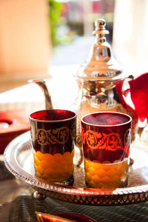 Moroccan mint tea with glass and teapot in Marrakech cafの写真素材
