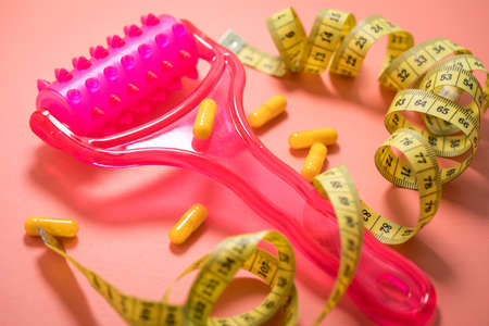 Cellulite roller for fascia massage, diet pills and measure tapeの写真素材