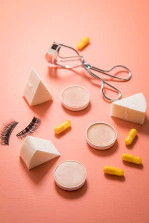 Make up tools sponge, beauty pills, camouflage pans, lash curler and false lashesの写真素材