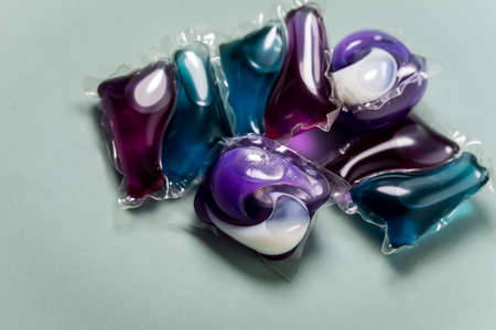 Liquid laundry detergent pods with gel and softener in blue and lilacの写真素材