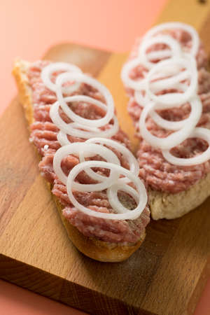Typical German raw ground pork meat with onions on bread rollsの写真素材