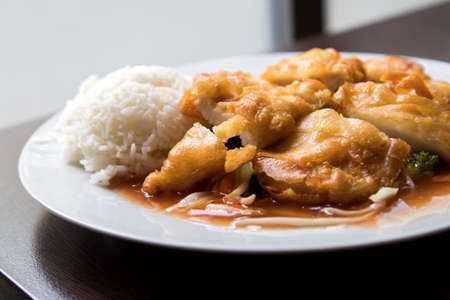 Fried chicken on Asian sweet sour sauce with rice in Asia restaurantの写真素材