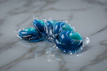 Liquid laundry detergent pods with gel and softener in blue