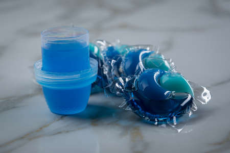Blue laundry detergent sorts variety in liquid gel and pod in washing doseの写真素材