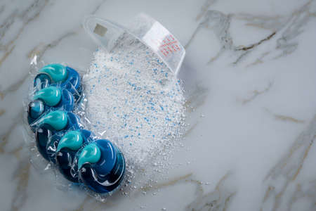 Blue laundry detergent sorts variety in powder and pod in washing doseの写真素材