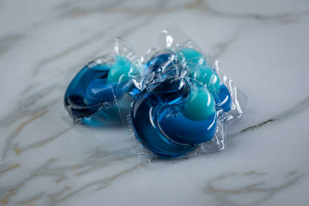 Liquid laundry detergent pods with gel and softener in blueの写真素材