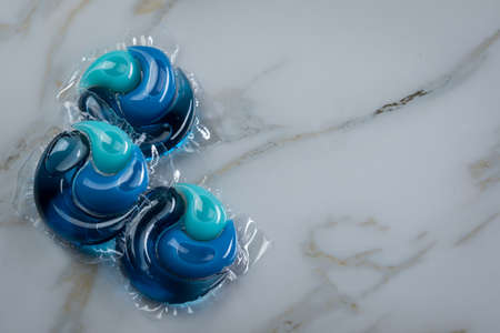 Liquid laundry detergent pods with gel and softener in blueの写真素材