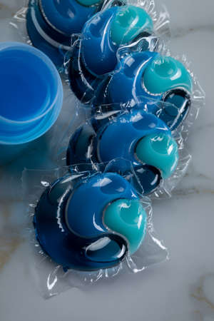 Blue laundry detergent sorts variety in liquid gel and pod in washing doseの写真素材