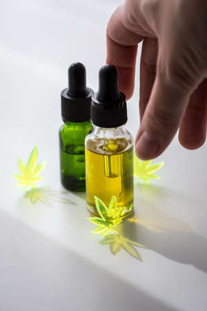 Woman using cannabis marijuana hemp CBD oil as pain killer and medical therapyの写真素材