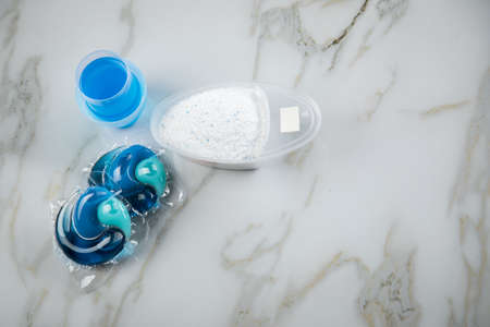 Blue laundry detergent sorts variety in powder, liquid gel and pod in washing dose