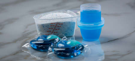 Blue laundry detergent sorts variety in powder, liquid gel and pod in washing doseの写真素材