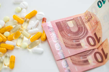 Money bills for white and yellow pills, tablets and capsule medicine