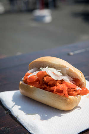 Typical North German Friesland cuisine is Alaska Pollack bun with onions on wooden table during fish...