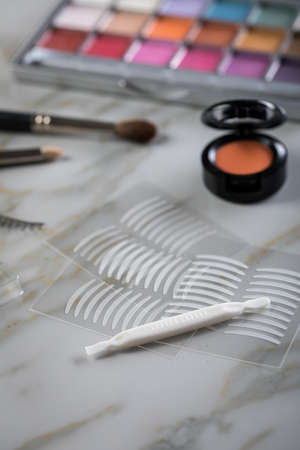Eye shadow palette, brushes, fake lashes, tweezers and artificial eyelid crease double tapes for eye...