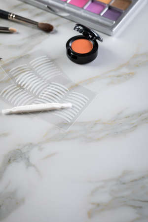 Eye shadow palette, brushes, fake lashes, tweezers and artificial eyelid crease double tapes for eye...