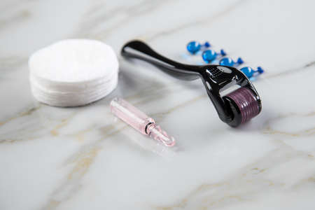 Derma roller and cosmetic vial ampoule for anti ageing lifting treatment in cosmetologist beauty salonの写真素材