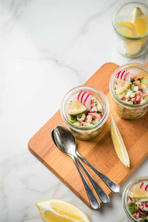 German Friesland north sea brown shrimps salad in glass mug with cucumber, red radish, dill and...