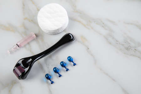 Derma roller and cosmetic vial ampoule for anti ageing lifting treatment in cosmetologist beauty salonの写真素材