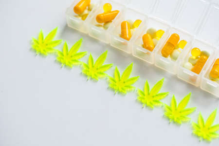 Pills, tablets,  capsules of cannabis marijuana hemp and CBD as pain killer and medical therapy in box dispenserの写真素材