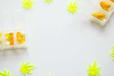Pills, tablets,  capsules of cannabis marijuana hemp and CBD as pain killer and medical therapy in box dispenserの写真素材