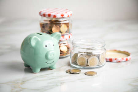 Piggy bank, 3 glass jars of loose cash and 2 Euro coins for housekeeping money and vacation or...