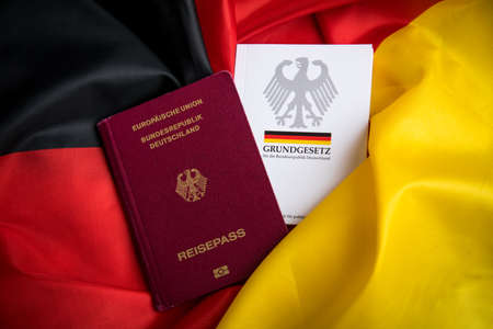 Passport and  constitution basic law book of Germany on German flagのeditorial素材