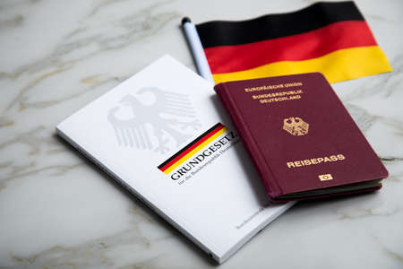 Passport and  constitution basic law book of Germany with flag on marble backgroundのeditorial素材
