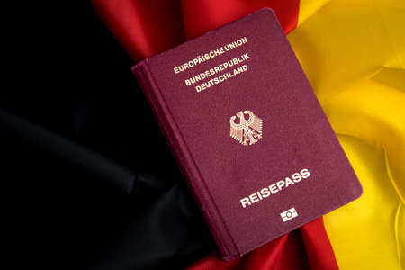 German Passport on flag of federal republic of Germanyのeditorial素材