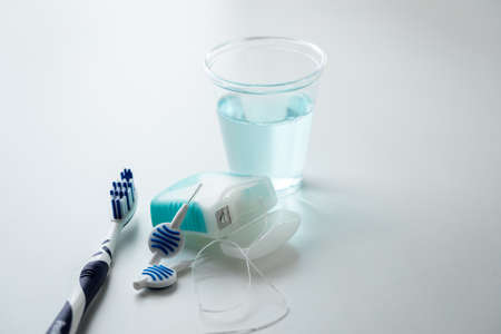 Toothbrush, mouthwash, floss and blue interdental brushes as equipment for daily dental care,...