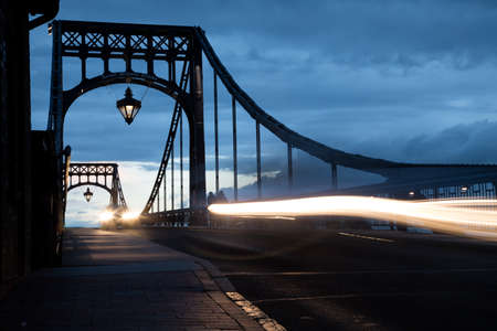 Traffic with cars and pedestrian on Kaiser-Wilhelm-Bridge a rotatable steel car bridge and landmark in Wilhelmshaven Germany during sunsetのeditorial素材