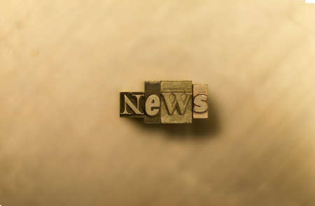 Gold letterpress news illustration on brown backgroundの写真素材