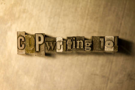 Lead metal "Copywriting 101" typography text on wooden backgroundの写真素材