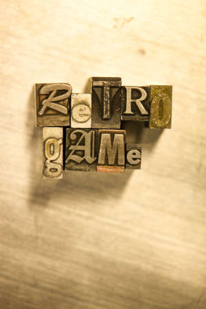 Lead metal "Retro game" typography text on wooden backgroundの写真素材
