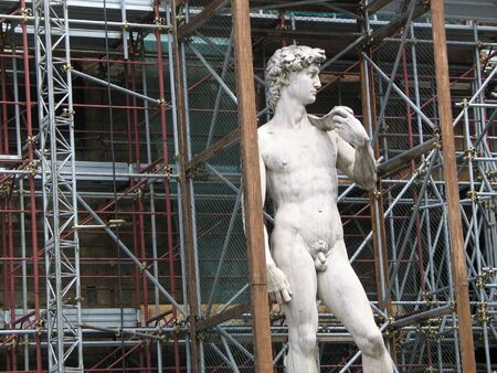 An old sculpture in the middle of a construction の写真素材