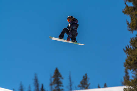 snowboarder pulling tricks on the Colorado Rockies slopes