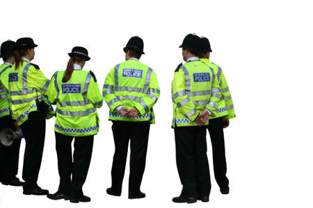 Group of UK Metropolitan police officers isolated on a white background