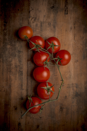 tomatoes on a rustic wood backgroundの写真素材