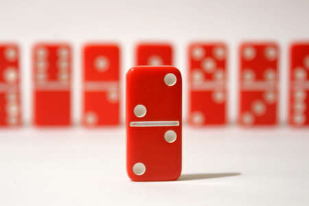 Red dominoes set against a white backgroundの写真素材